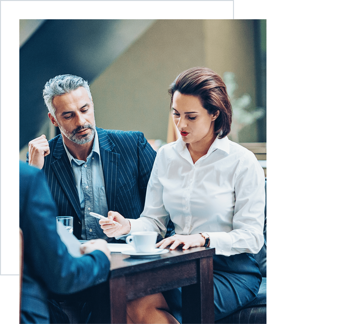 Professionals collaborating over coffee