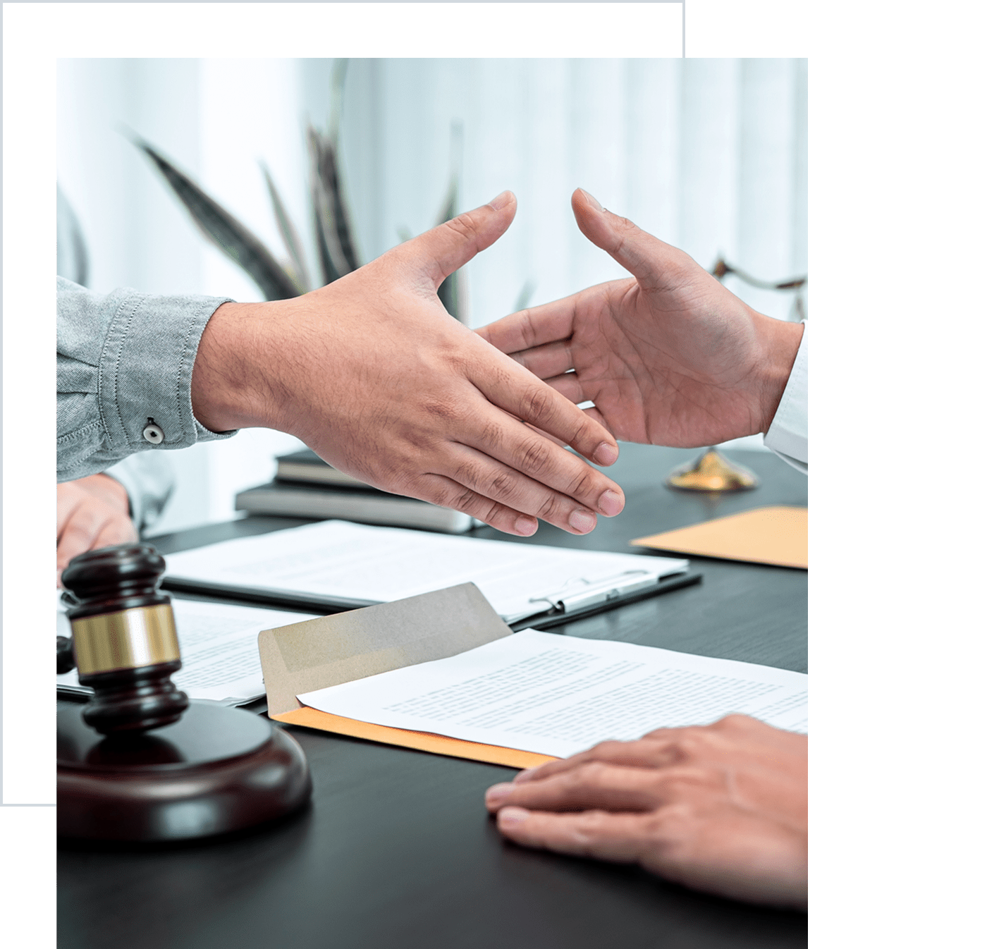 Lawyers shaking hands in office
