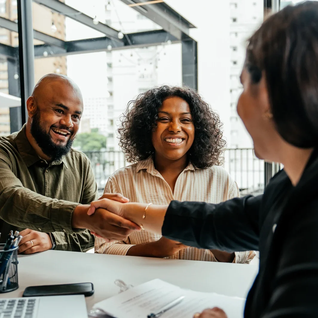 Smiling couple meeting with agent